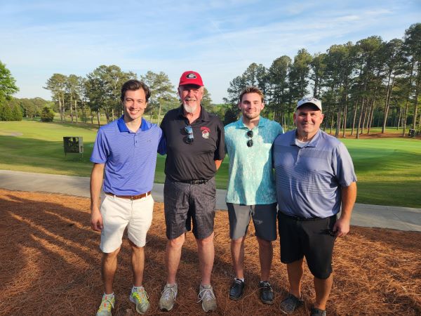 Image of 2023 Golf Scramble winners with UGA Golf Course in the background
