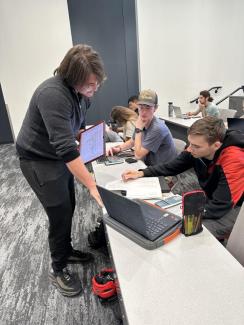 Chemistry Learning Assistant (CLA) working with students in a classroom