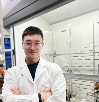 Portrait of Weihao Ma, speaker, with a lab background