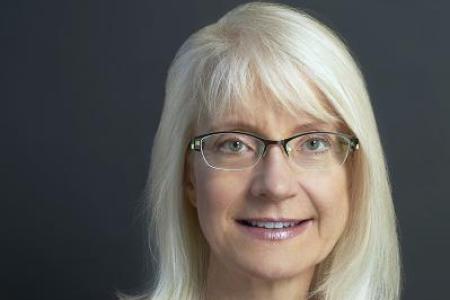 Headshot of Prof. Jennifer Brodbelt, guest speaker, woman with blonde hair, wearing glasses and a dark red top