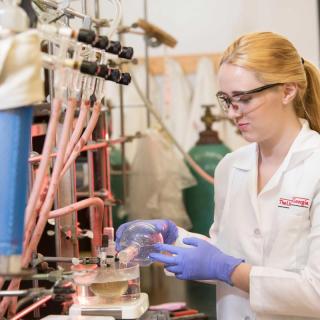 Chemistry undergraduate student Kaitlin Luedecke working in a laboratory.